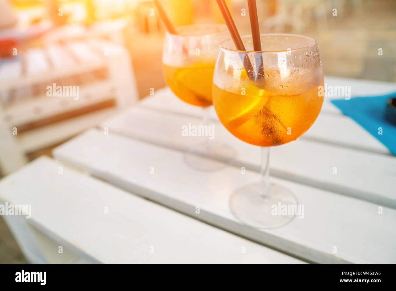 Delicious classic iced aperol spritz cocktail with ice cubes on a hot tropical beach in summer sunshine Stock Photo