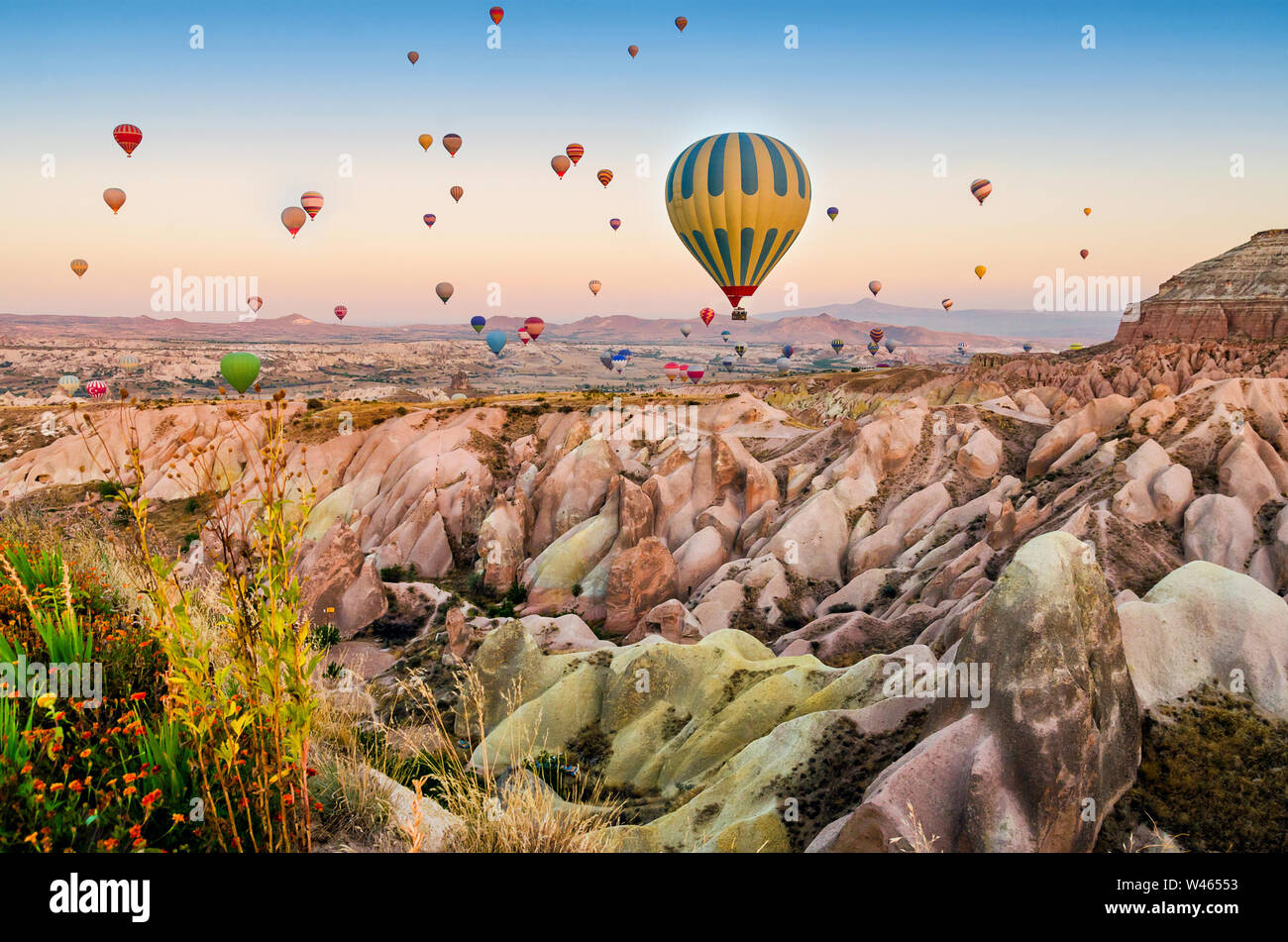 Hot air balloon flying over rock landscape at Cappadocia Turkey Stock ...