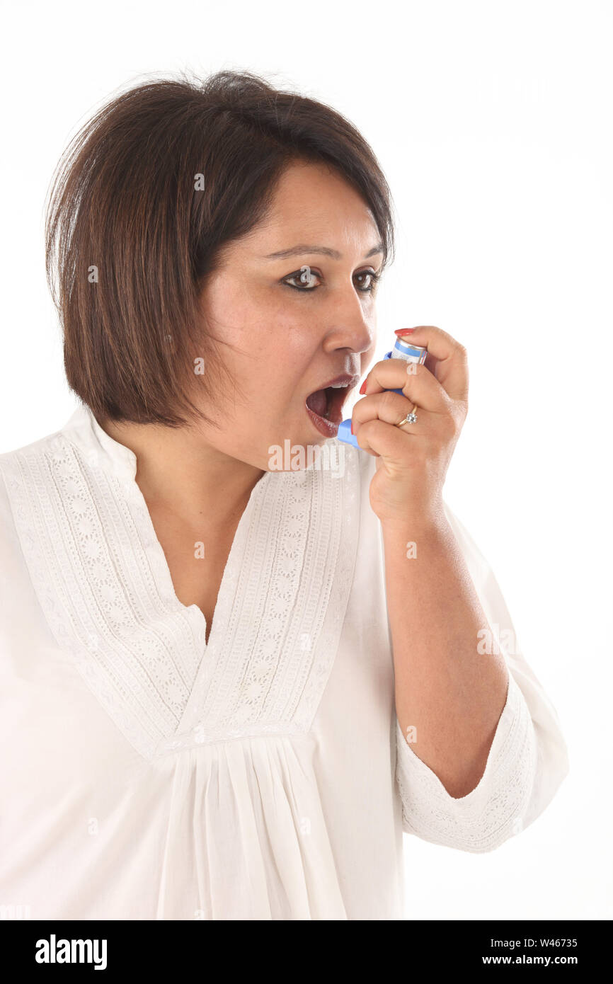 Woman using asthma inhaler Stock Photo Alamy