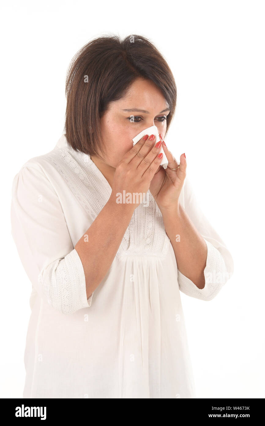 Woman blowing nose with tissue paper Stock Photo Alamy