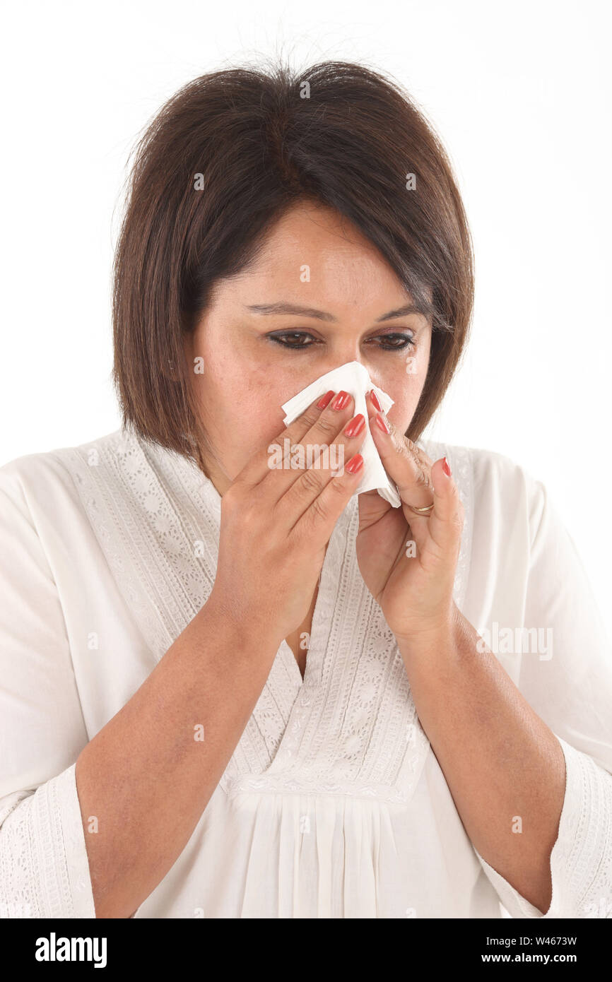 Woman blowing nose with tissue paper Stock Photo Alamy