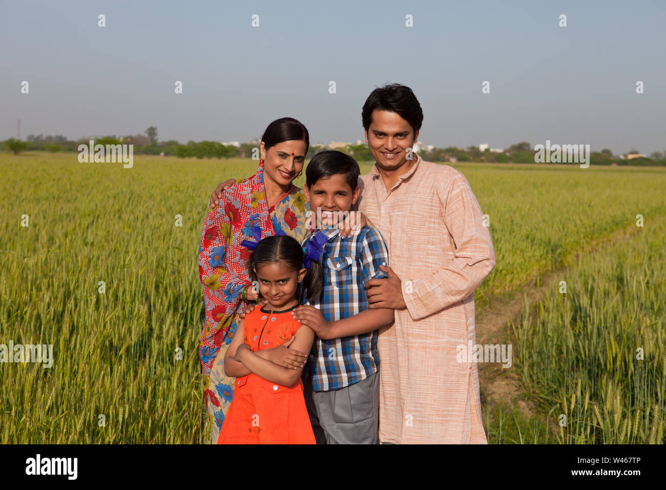 Rural family standing in a field Stock Photo Alamy