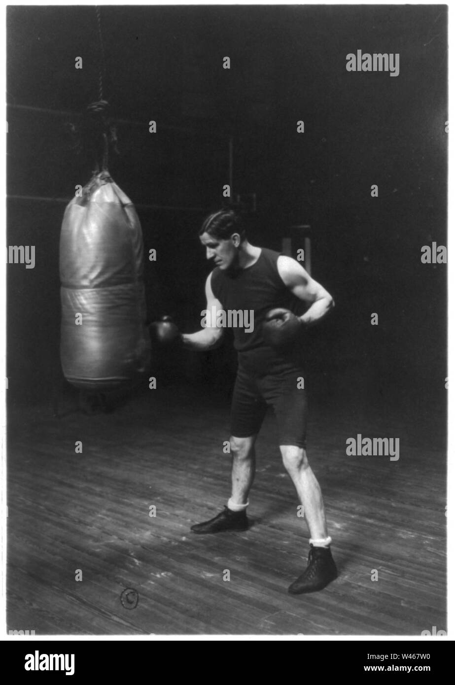 Corbett punching the bag to get in condition to handle Jeffries for the championship fight. First photos taken with gloves in five years Stock Photo