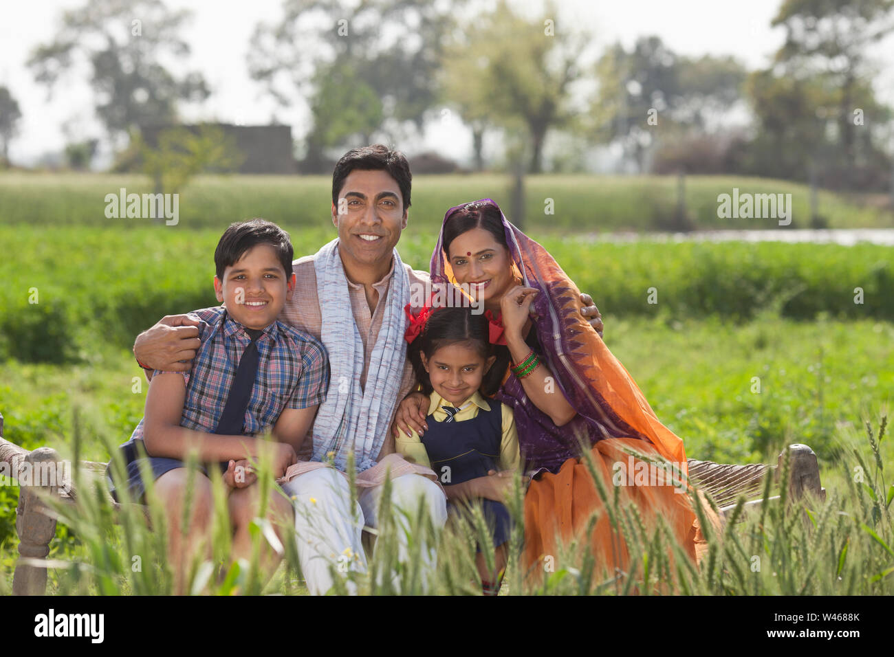 Rural family sitting in a field Stock Photo - Alamy