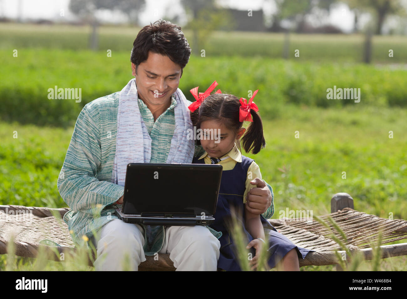 Man using laptop with his daughter Stock Photo