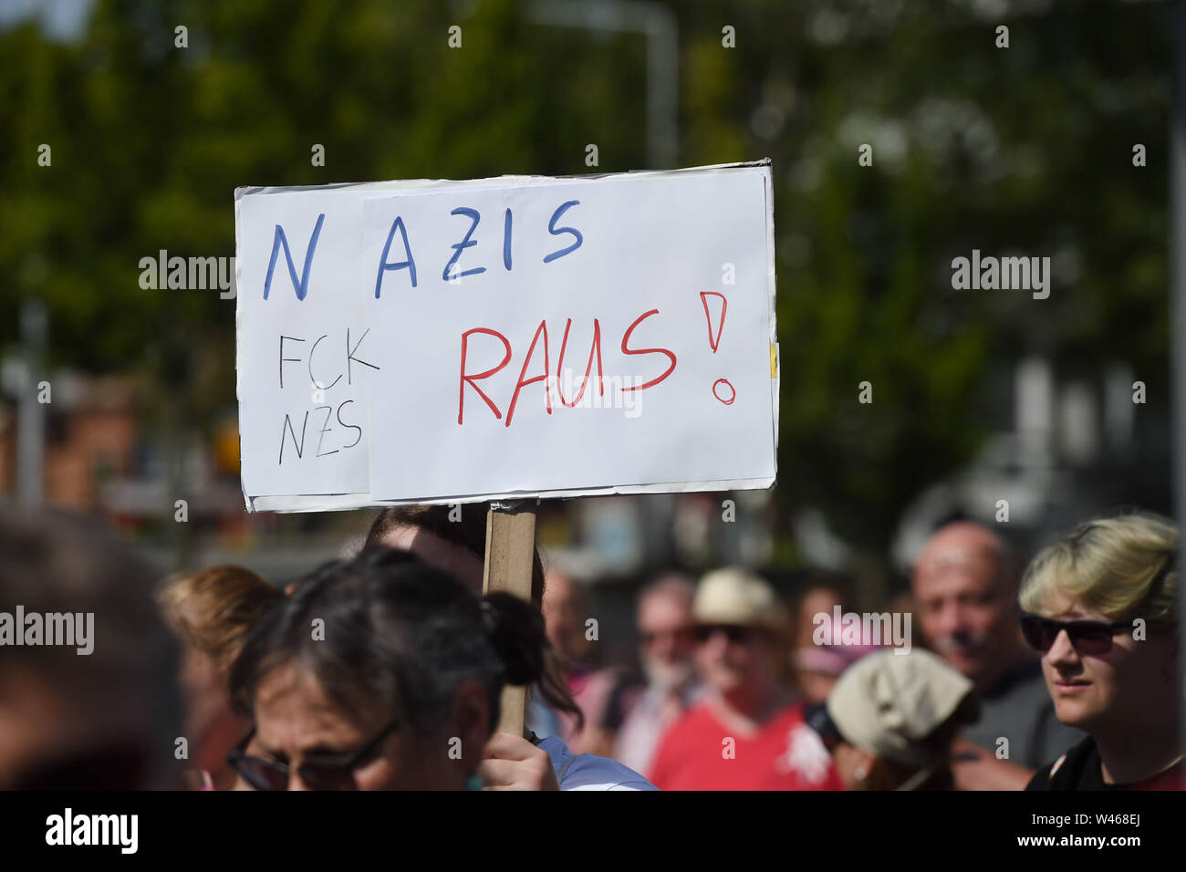Kassel, Germany. 20th July, 2019. Thousands demonstrate against the march of the smallest party 'The Right'. The party had called for a demonstration in Kassel against media prejudgement in connection with the Lübcke case. A massive police presence is to prevent possible riots between the two camps. The poster says 'Nazis out.' Credit: Uwe Zucchi/dpa/Alamy Live News Stock Photo