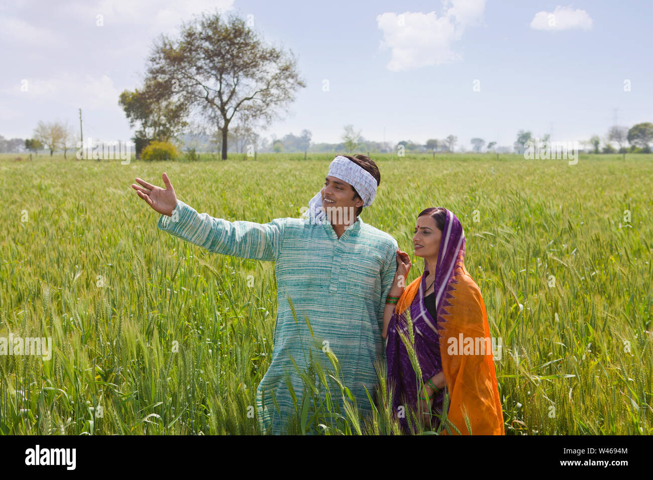 Farmer showing field to his wife Stock Photo - Alamy