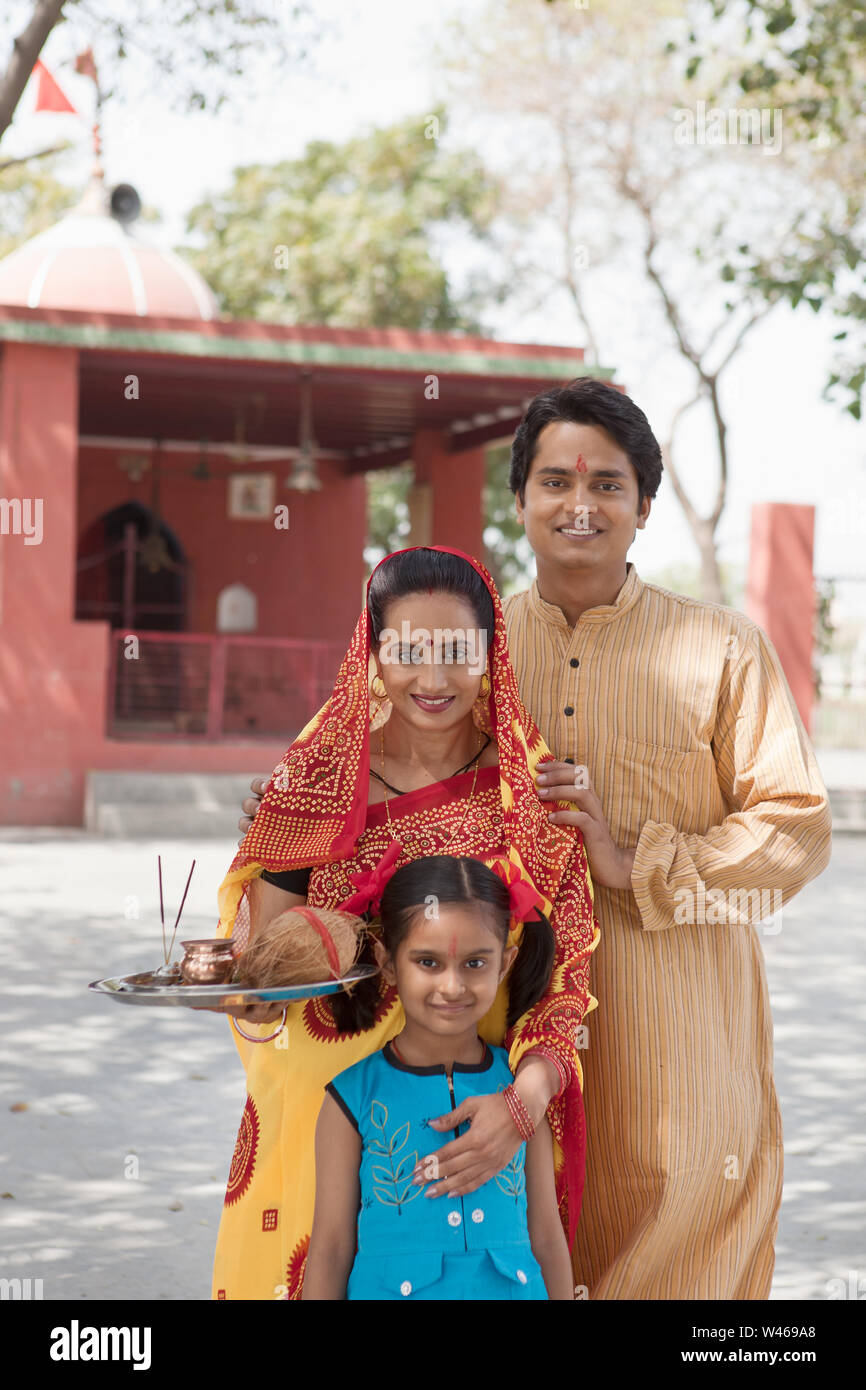 Portrait of a family smiling in front of temple Stock Photo