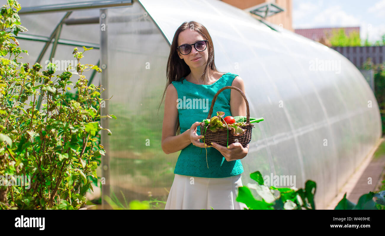 Young woman standing near her greenhouse outdoors Stock Photo - Alamy