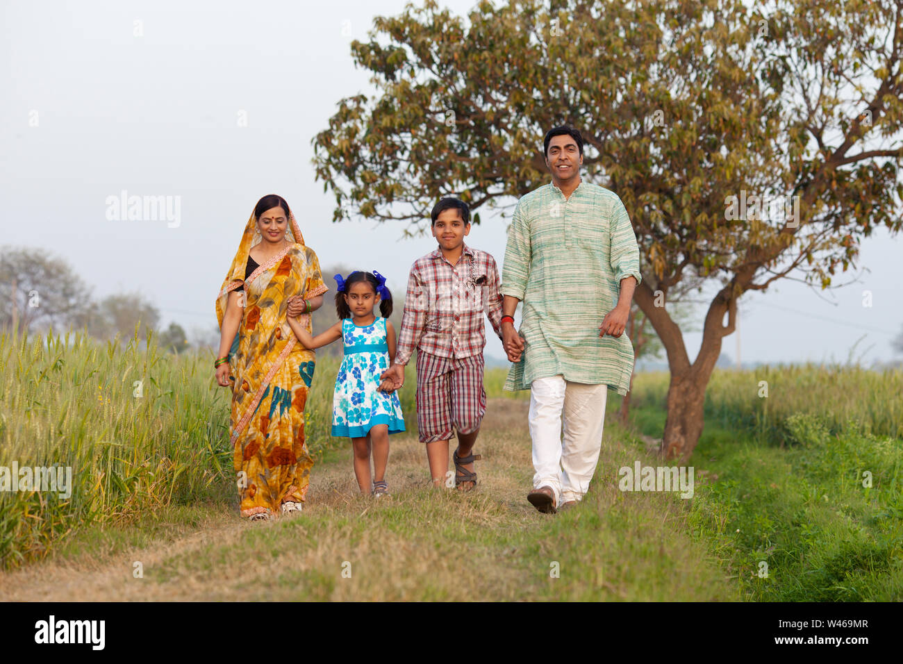 Rural family walking in a field Stock Photo Alamy