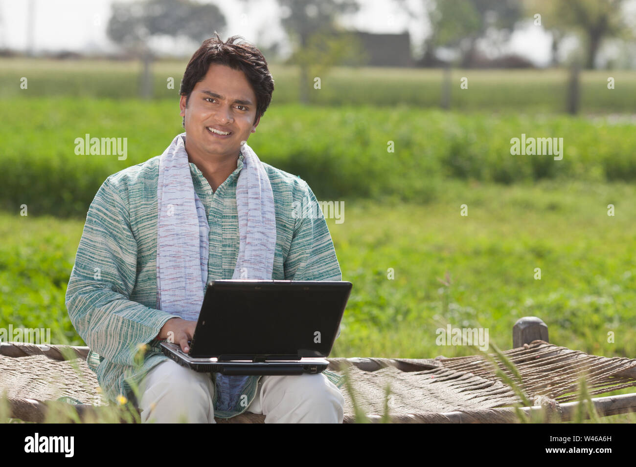 Farmer using a laptop Stock Photo - Alamy