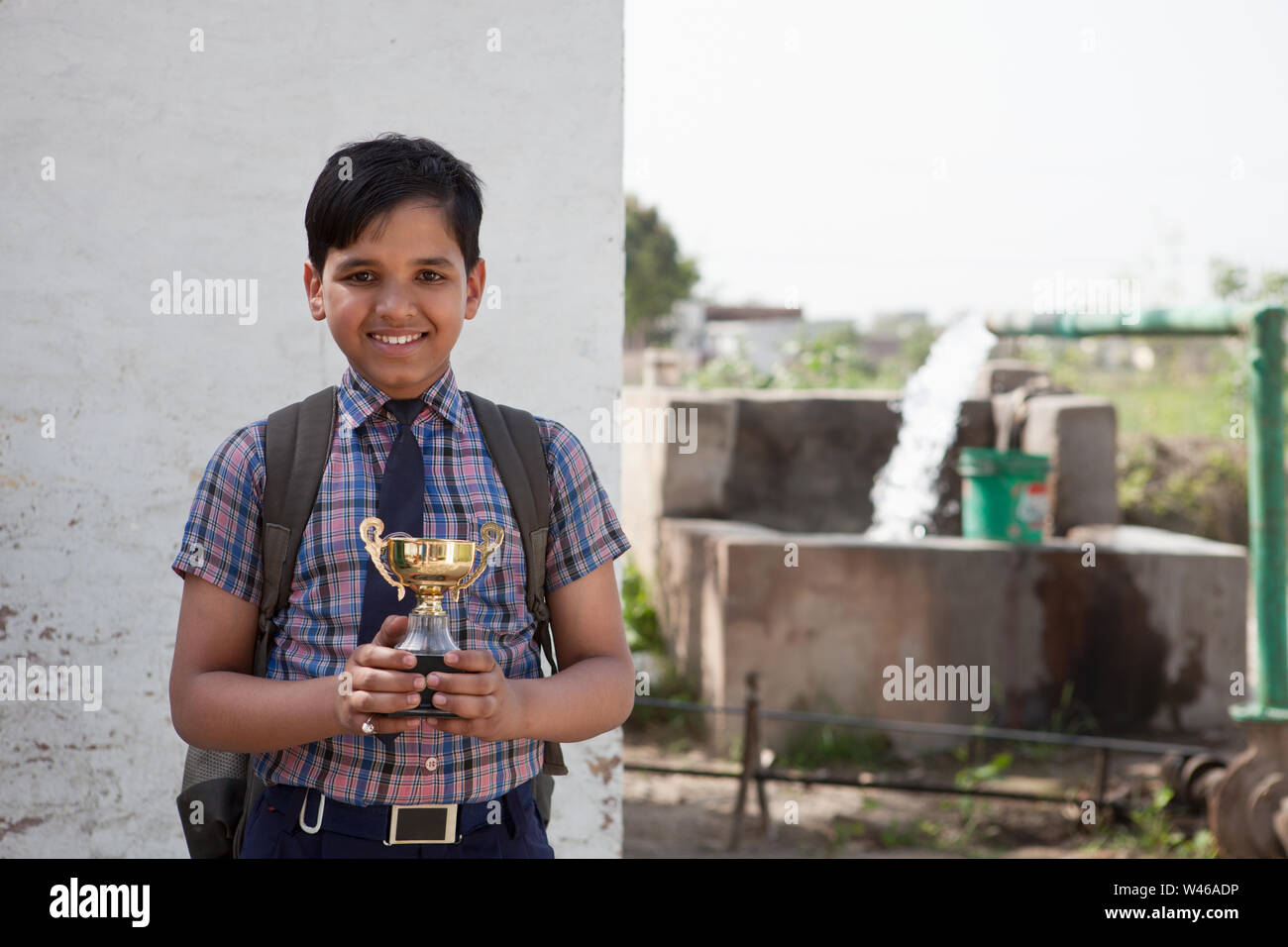 Portrait of a schoolboy holding a trophy Stock Photo