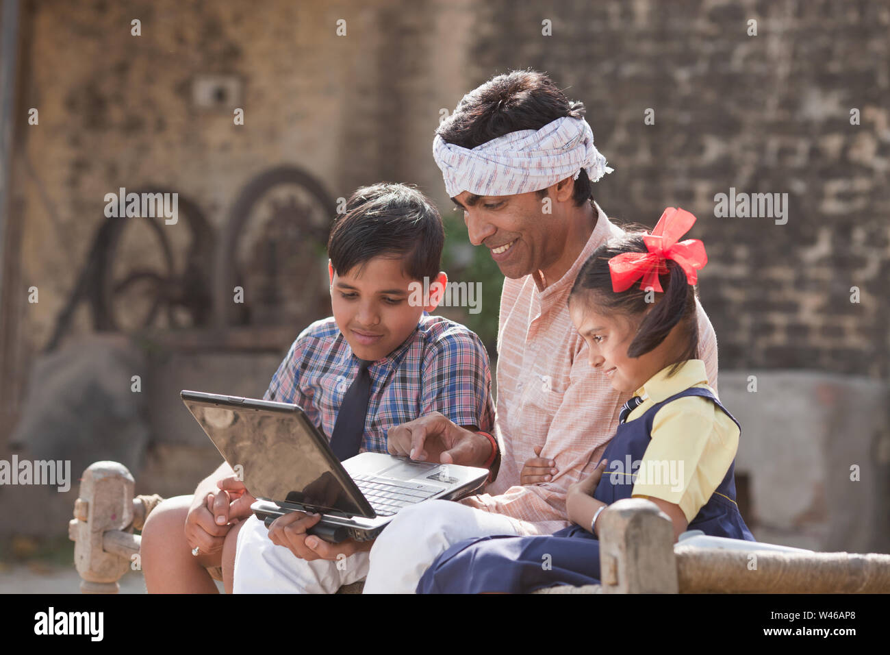 Man using laptop with his children Stock Photo