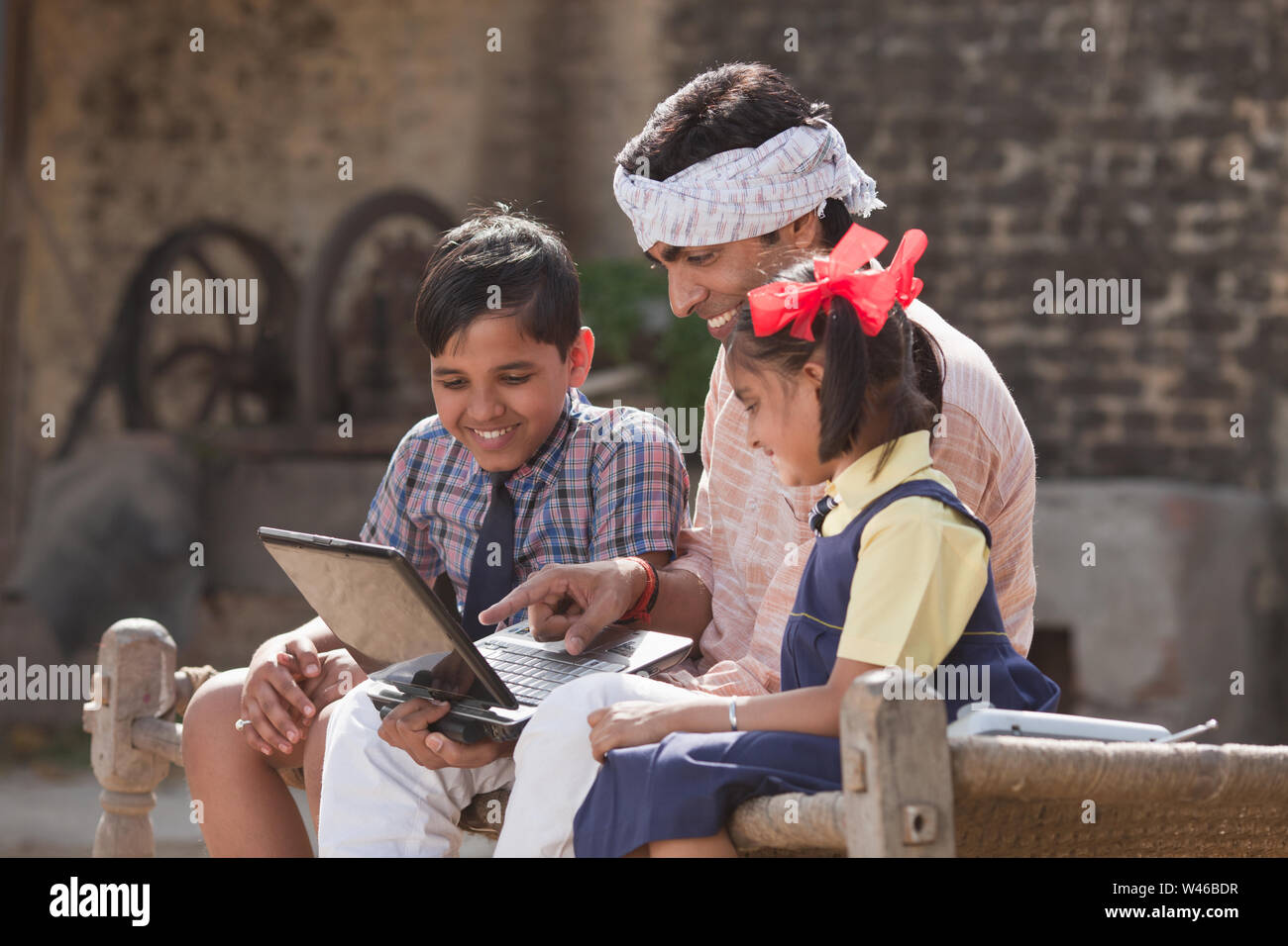 Man using laptop with his children Stock Photo