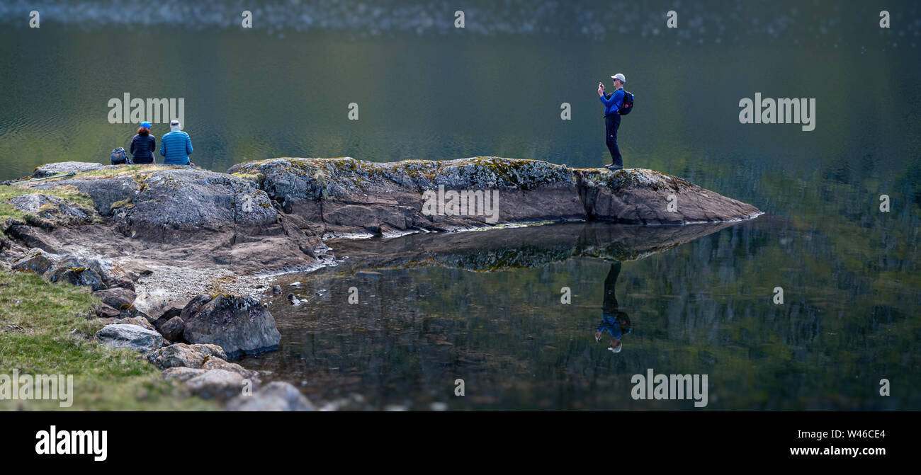 Candid photo of the candid photographer reflected in the lake Stock Photo