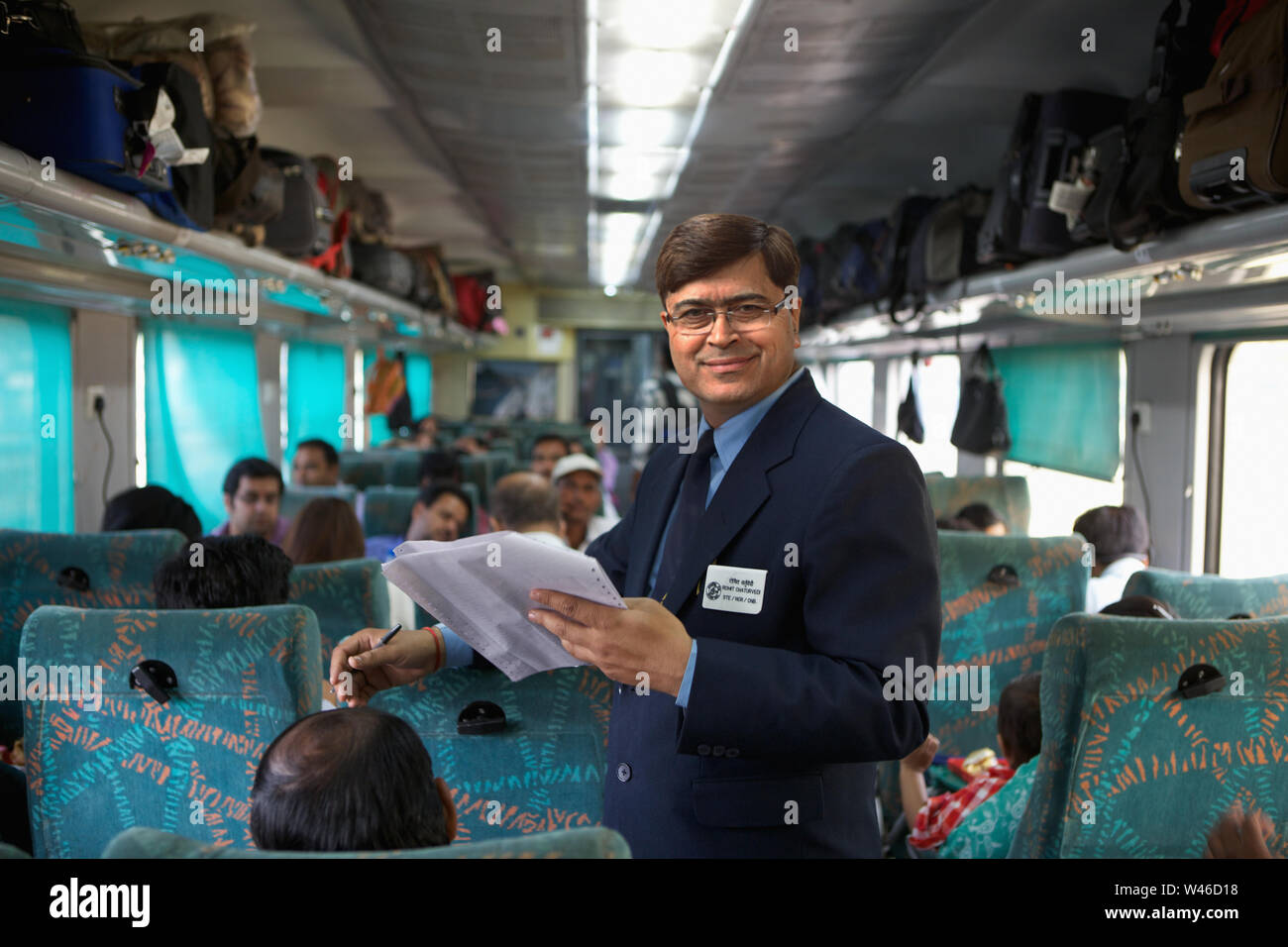 Ticket collector checking tickets in a train Stock Photo
