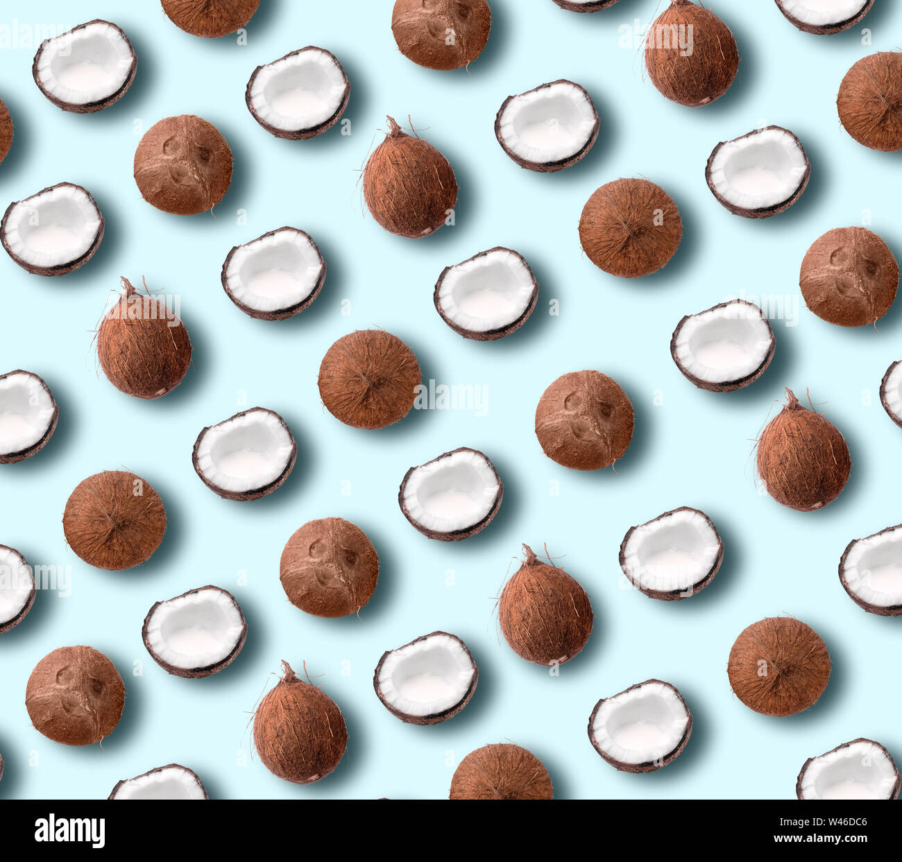 Coconut pattern on pastel blue background. Summer concept. Flat lay, top view. Banner Stock Photo