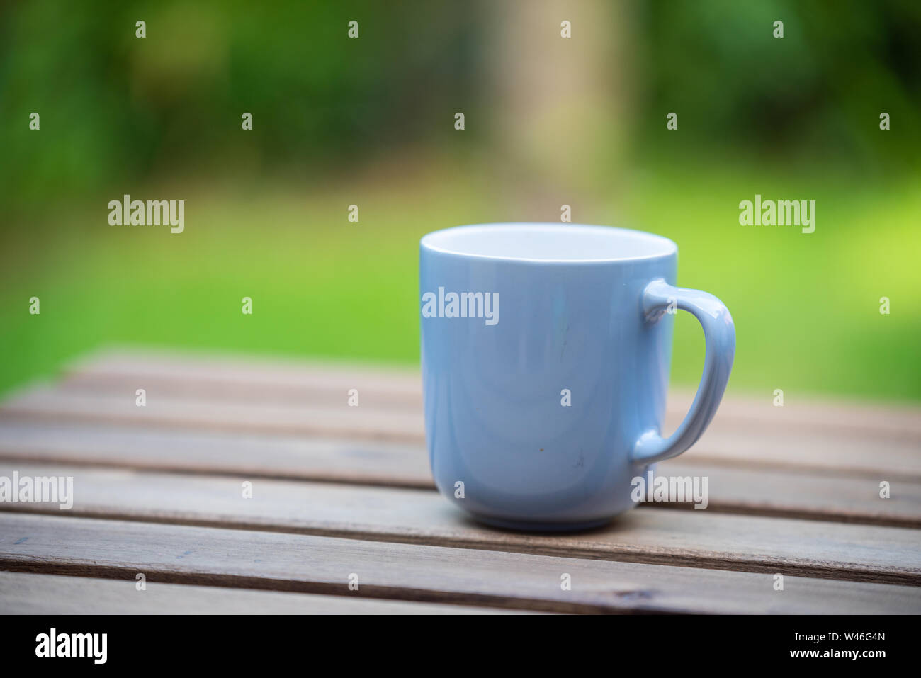 sitting in the garden early in the morning with a hot cup of  coffee Stock Photo