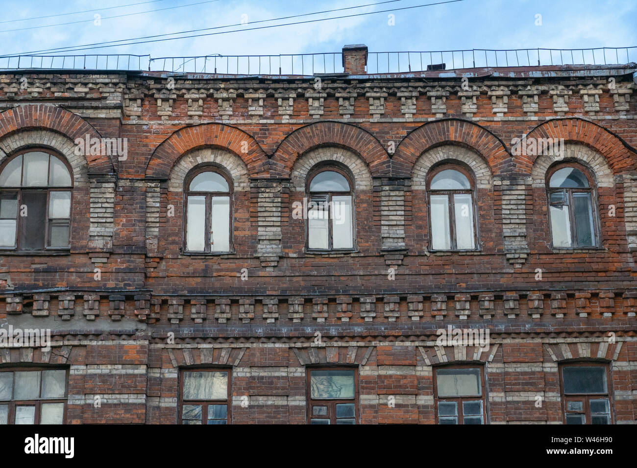 Facade of old brick building with windows on sky background Stock Photo ...