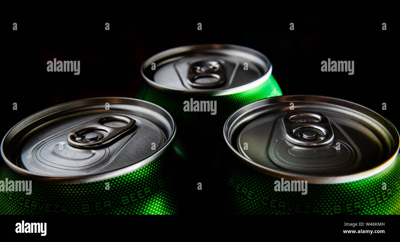 Three green cans of beer. Background for a pub. Beer store. Relax at