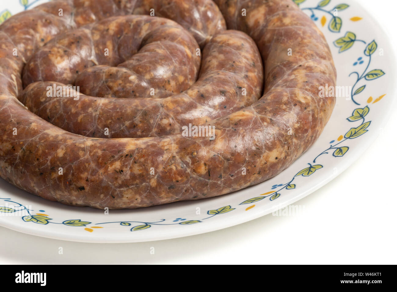 Homemade stuffed pork sausages in a a plate isolated on white Stock