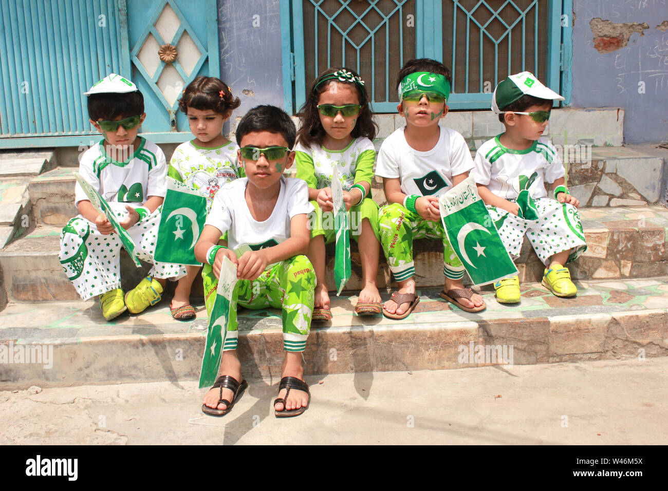 children wearing green and white colors dress and held in hands Pakistani  flags Stock Photo - Alamy