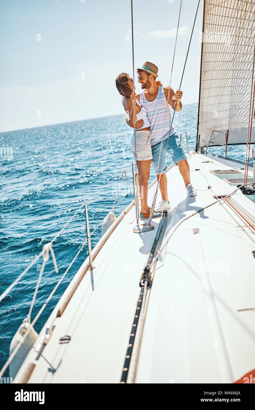 happy-young-man-and-woman-on-the-luxury-yacht-enjoying-together-W46MJX.jpg