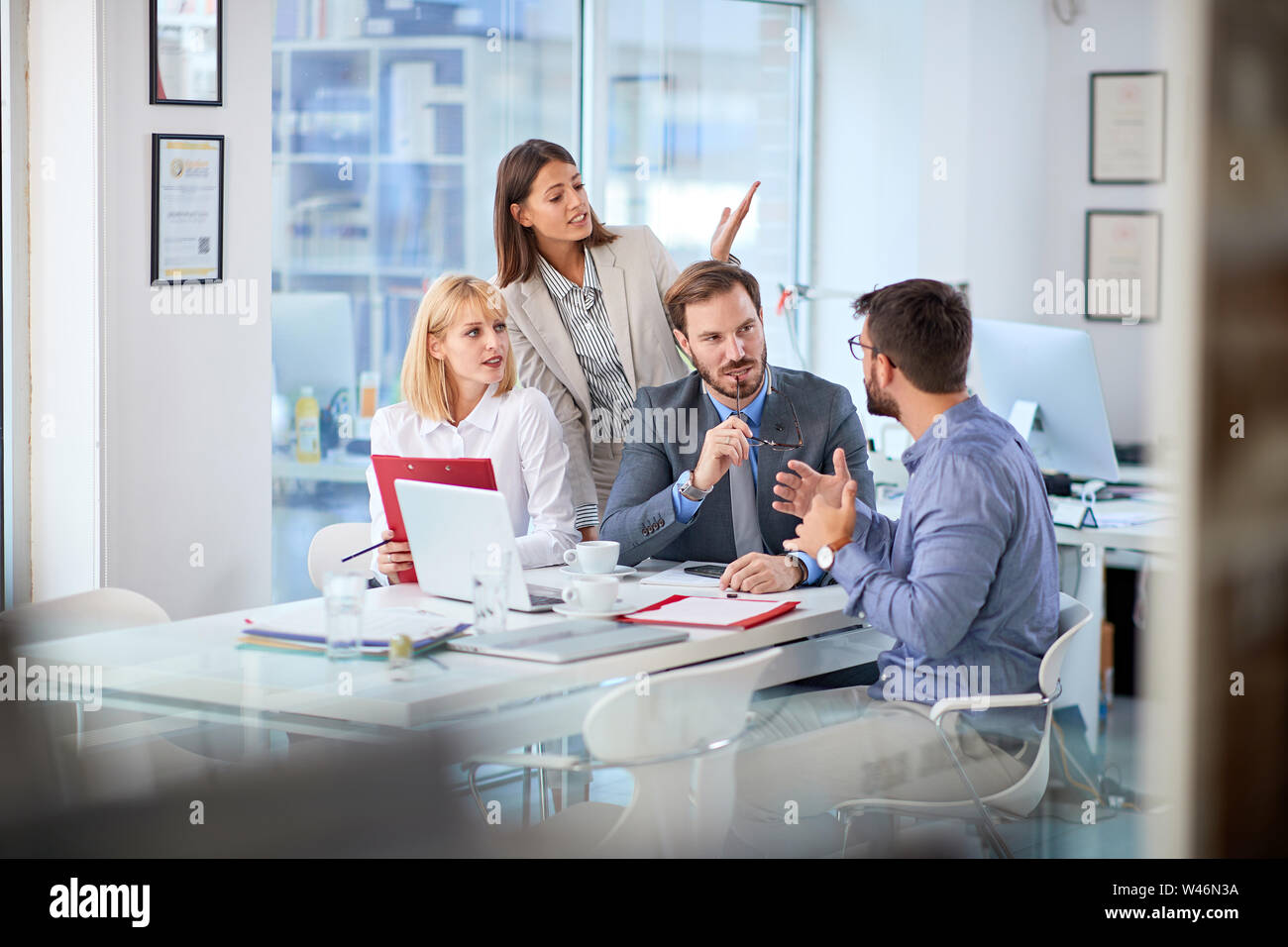 Group of businesspeople presenting ideas to clients at his office Stock Photo