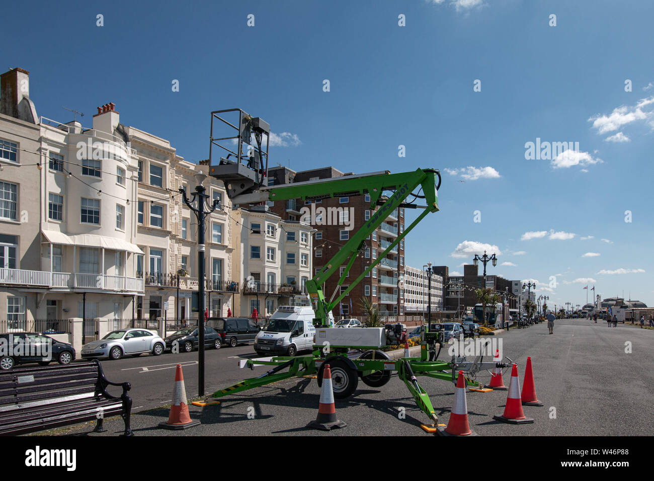 Cherry picker replacing light bulbs in the seafront lights in Worthing, West Sussex,UK Stock Photo