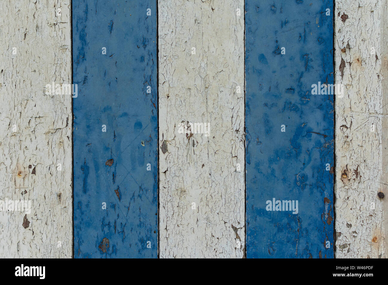 Wooden painted shelves three white shelves two blue shelves the paint peels off it Stock Photo