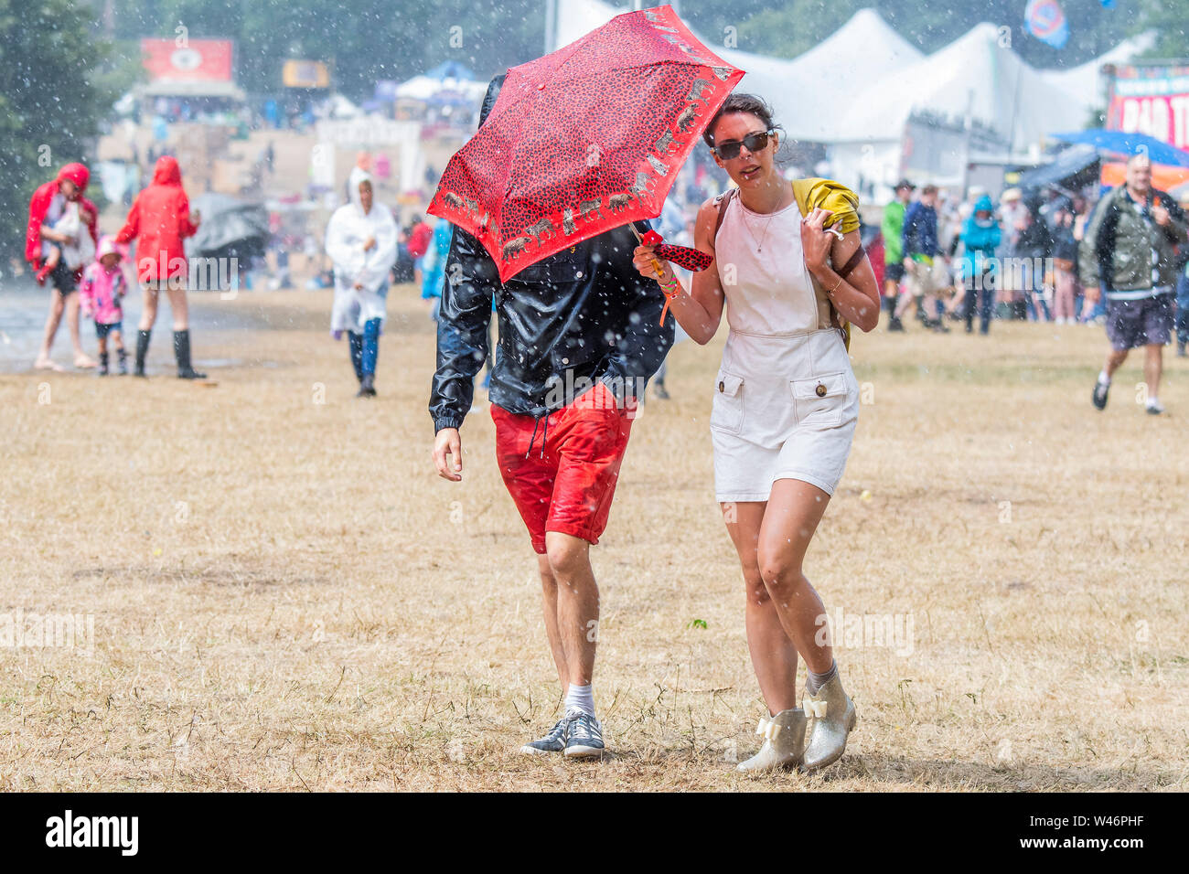 Henham Park, Suffolk, UK, , 20 July 2019. The rain falls and people dash for cover - The 2019 Latitude Festival. Credit: Guy Bell/Alamy Live News Credit: Guy Bell/Alamy Live News Credit: Guy Bell/Alamy Live News Credit: Guy Bell/Alamy Live News Stock Photo