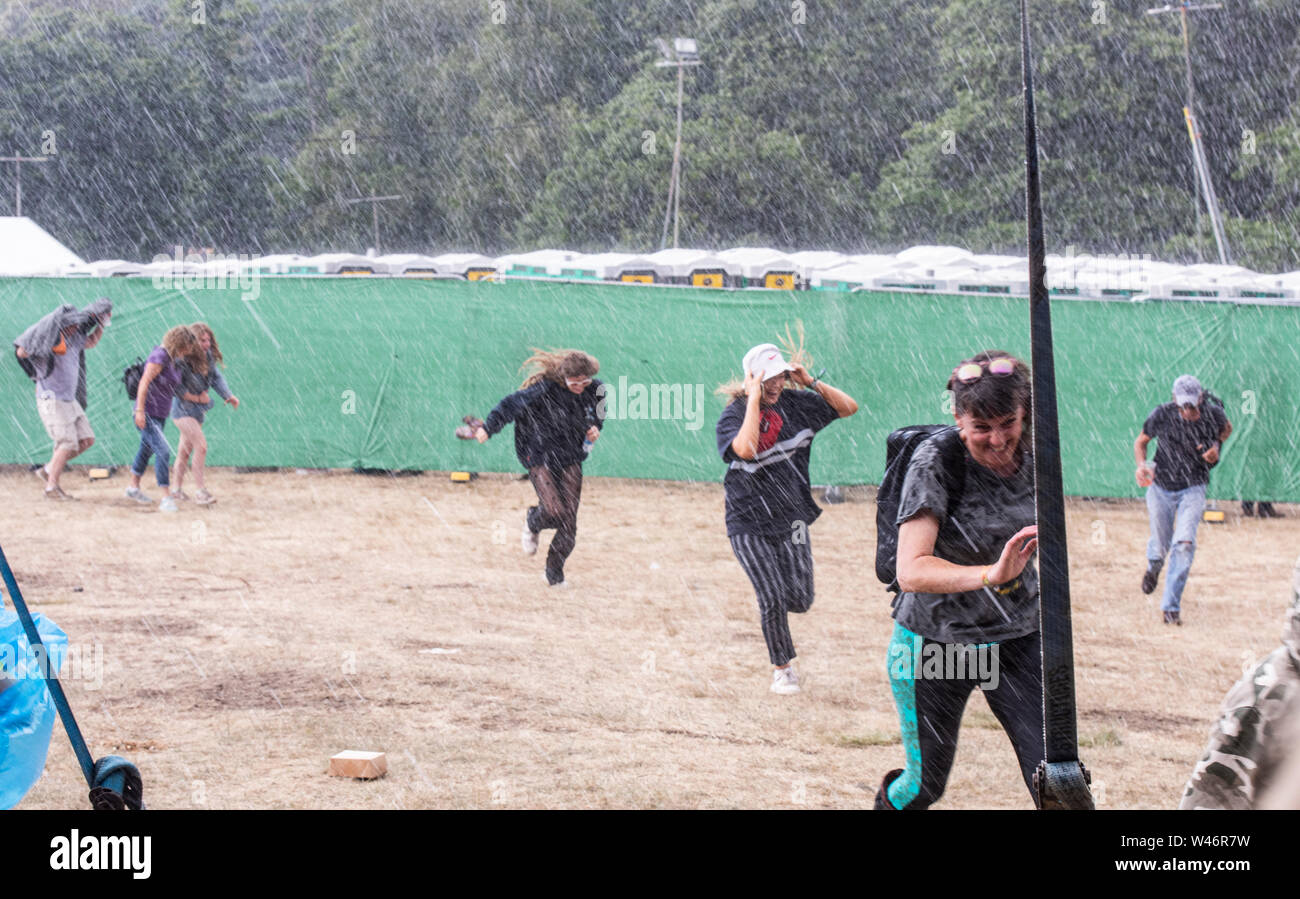 Festival goers running for shelter from massive unexpected downpour, Latitude Festival, Henham Park, Suffolk, UK on 20th July 2019 Stock Photo