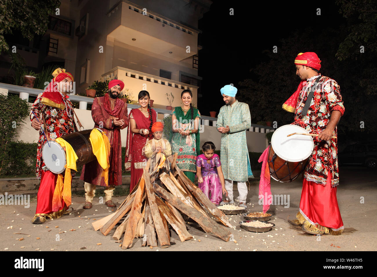 Family celebrating Lohri festival, Punjab, India Stock Photo