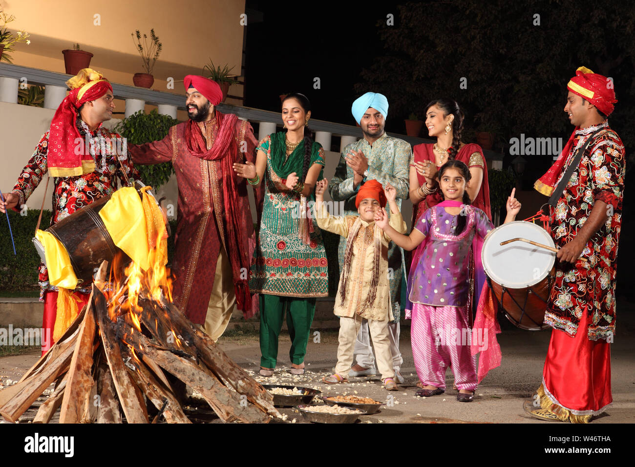 Family celebrating Lohri festival, Punjab, India Stock Photo