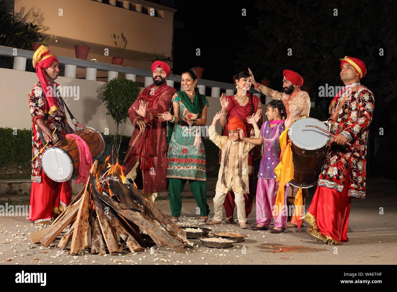 Family celebrating Lohri festival, Punjab, India Stock Photo