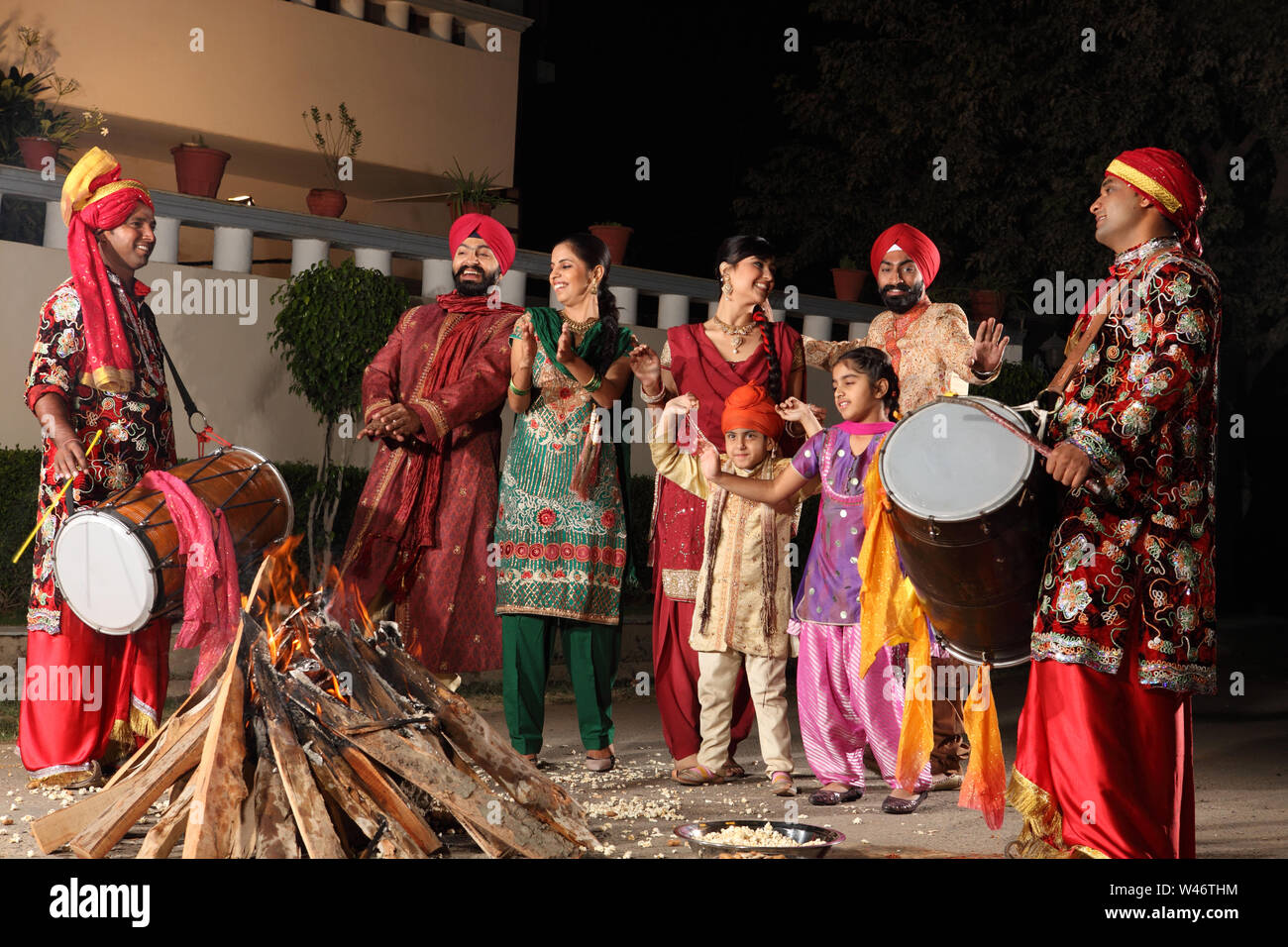 Family celebrating Lohri festival, Punjab, India Stock Photo