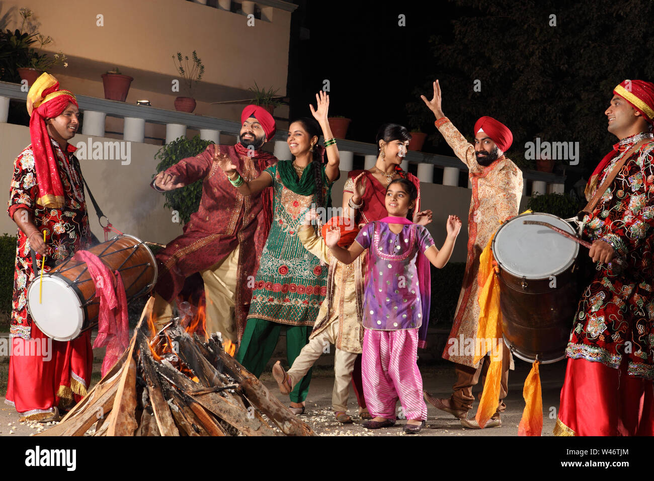 Family celebrating Lohri festival, Punjab, India Stock Photo