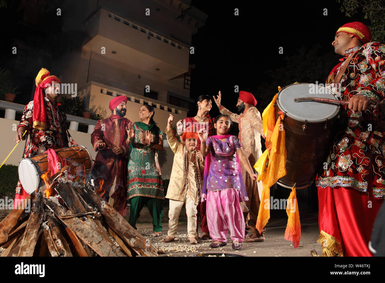 Family celebrating Lohri festival, Punjab, India Stock Photo