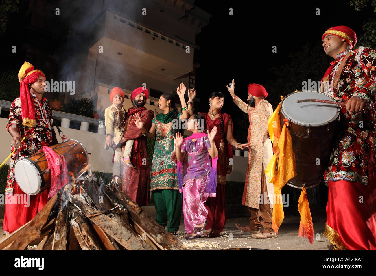 Family celebrating Lohri festival, Punjab, India Stock Photo