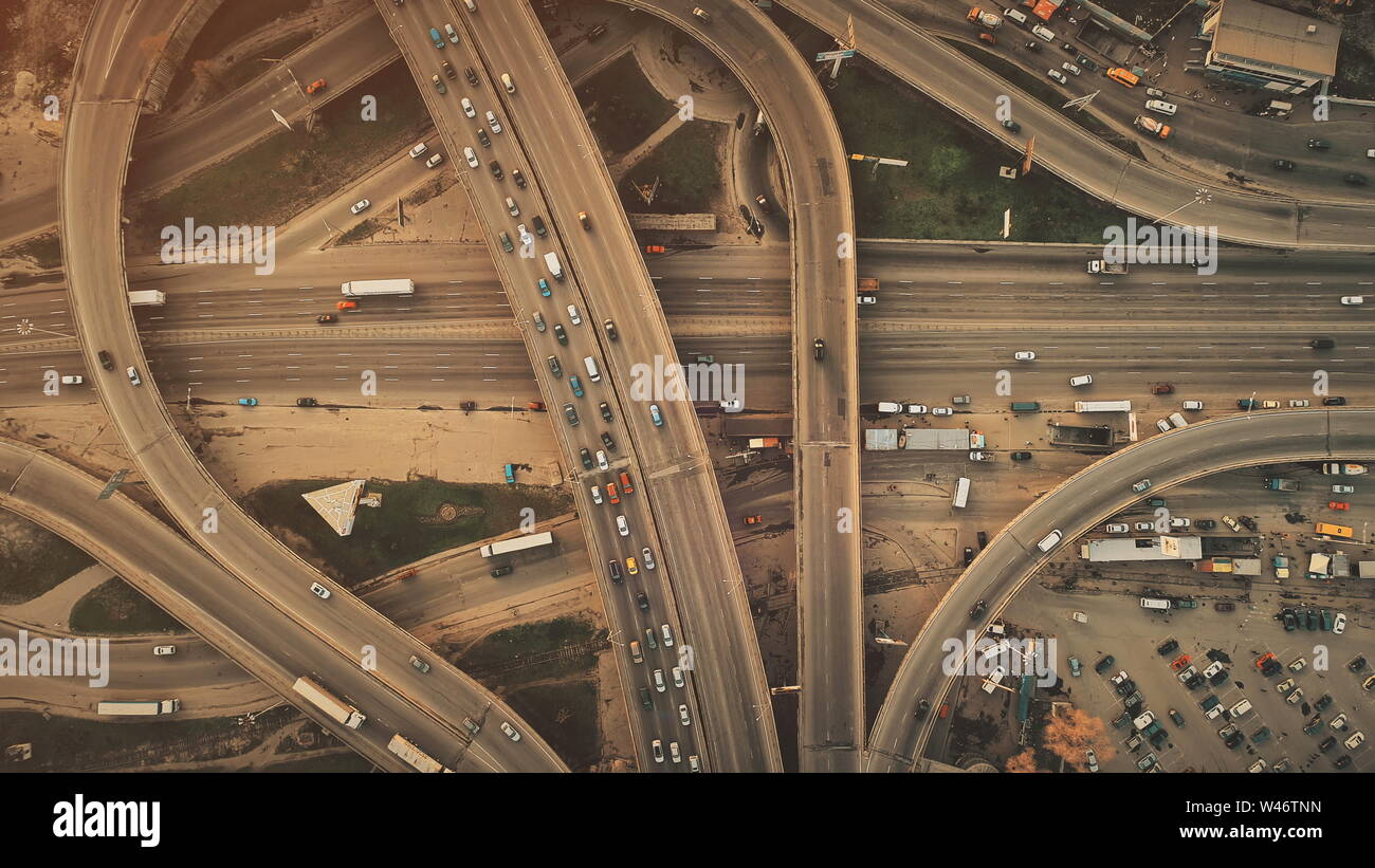 Aerial Top View of Epic City Highway Car Traffic System. Busy Road Junction Street Route Vehicle Motion Overview. Business District Transport Development Travel Concept. Drone Flight Shot Stock Photo