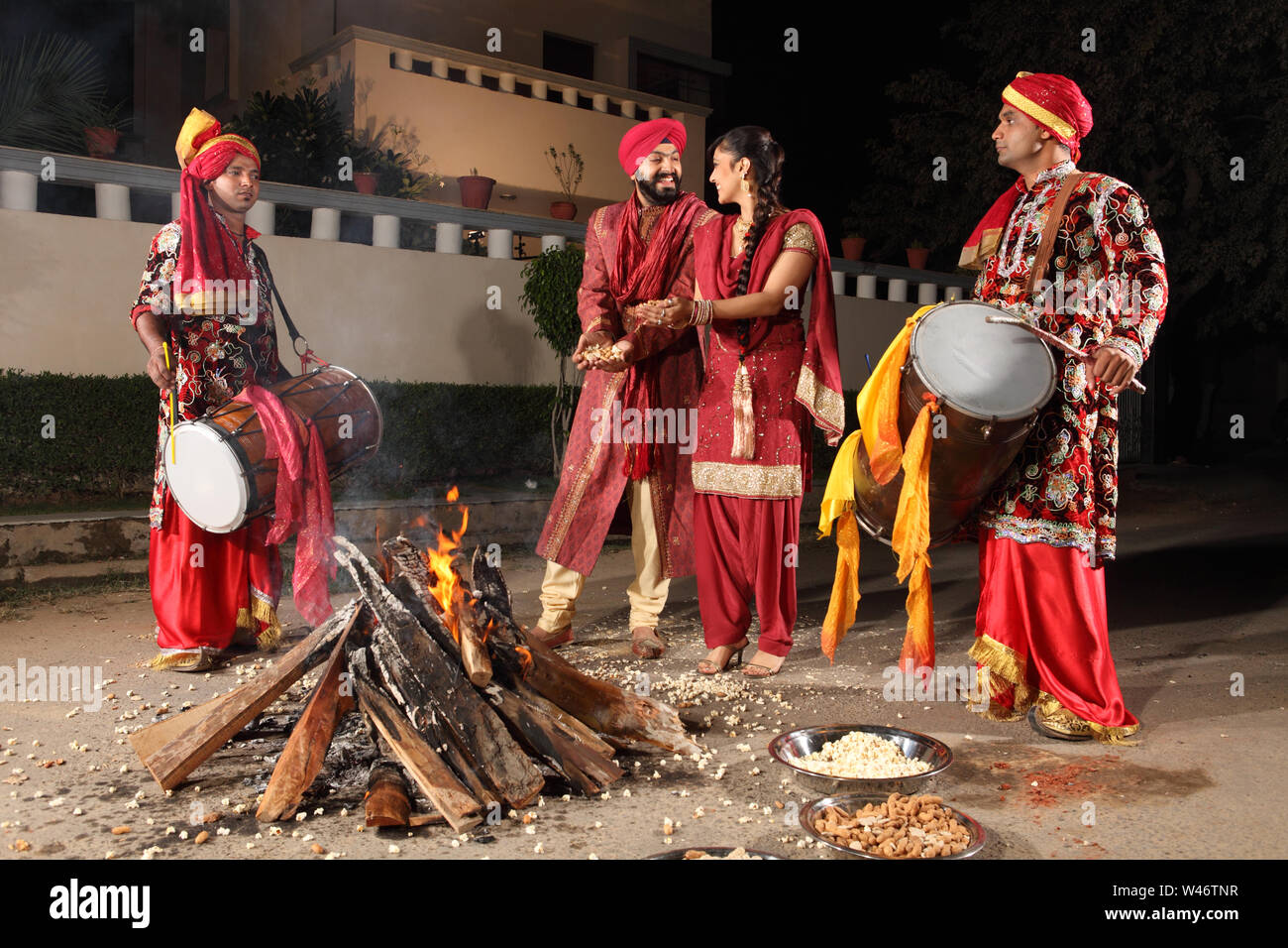 Couple celebrating Lohri festival, Punjab, India Stock Photo