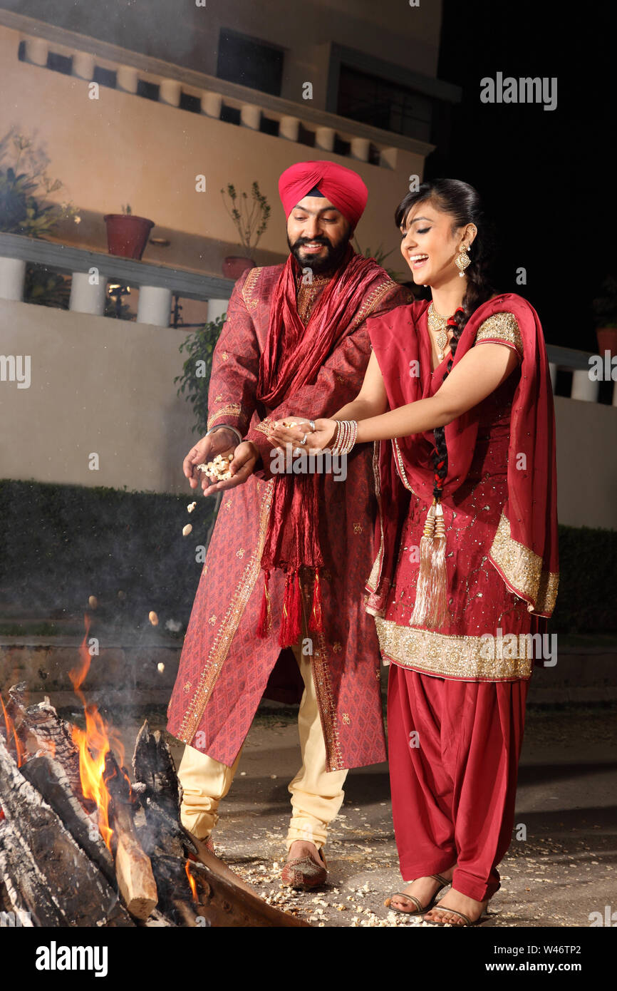 Couple celebrating Lohri festival, Punjab, India Stock Photo