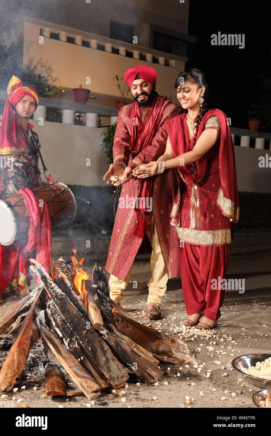 Couple celebrating Lohri festival, Punjab, India Stock Photo