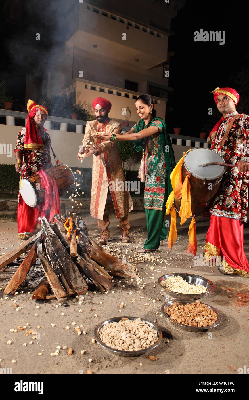 Couple celebrating Lohri festival, Punjab, India Stock Photo