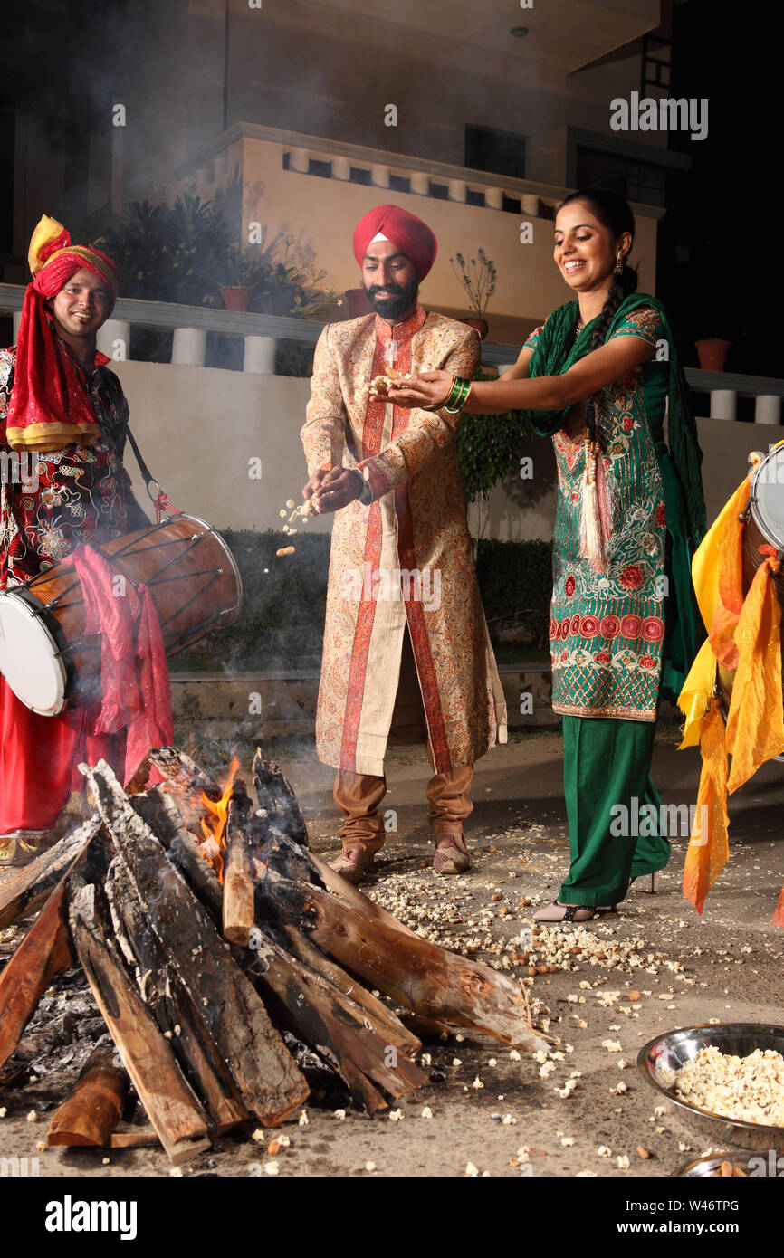 Couple celebrating Lohri festival, Punjab, India Stock Photo