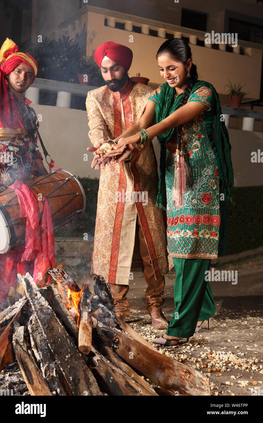 Couple celebrating Lohri festival, Punjab, India Stock Photo