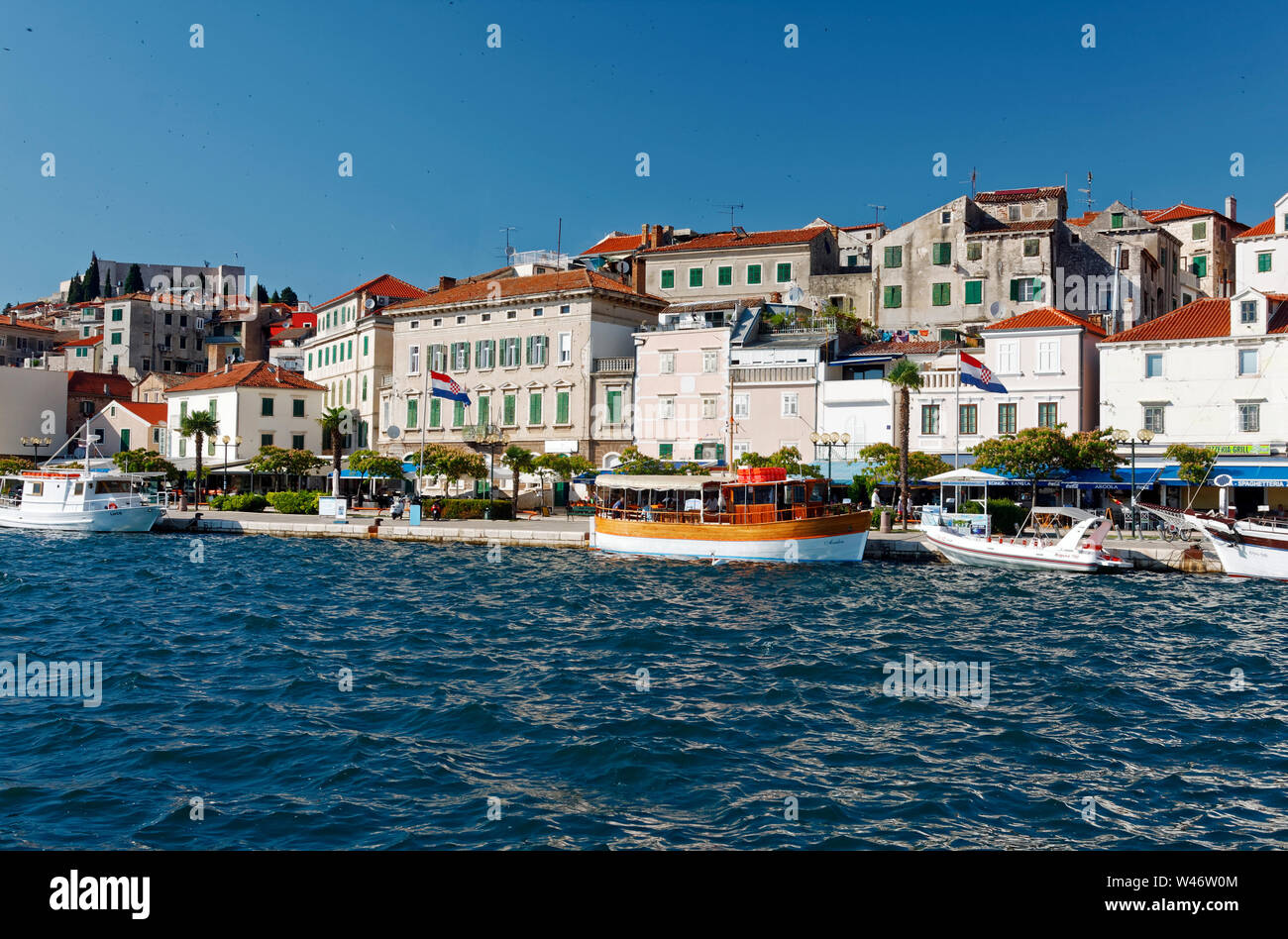 harbor scene, coastline, old buildings, boats docked, Adriatic Sea, water, maritime, Sibenik; Croatia; Europe; summer, horizontal Stock Photo