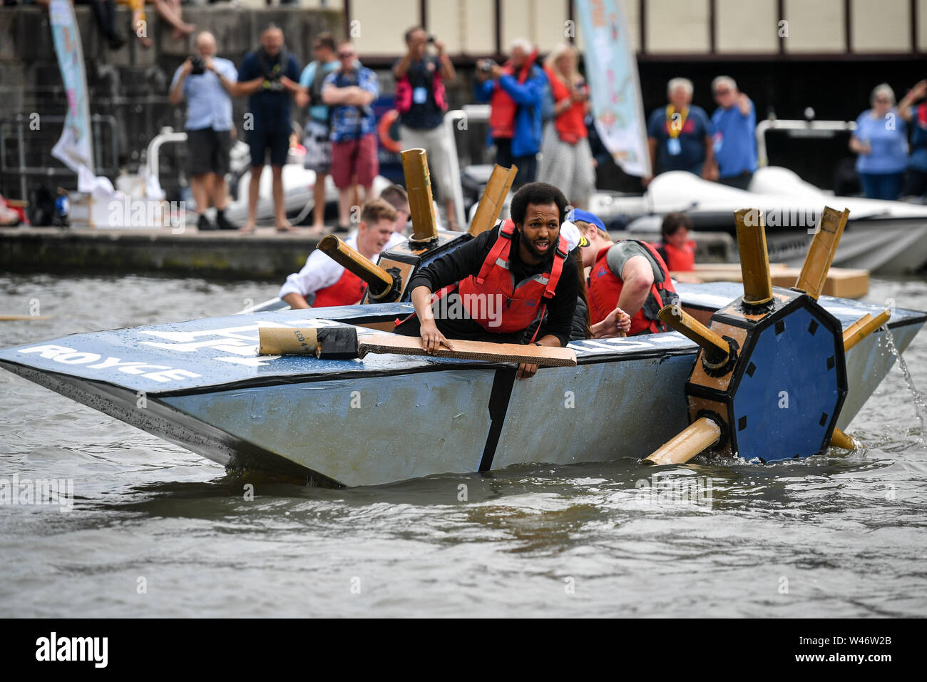 An ingenious paddle boat takes part in the cardboard boat race as they use cardboard tubes on a spindle during the Bristol Harbour festival, where hundreds of vessels have gathered in the city centre floating harbour. Stock Photo