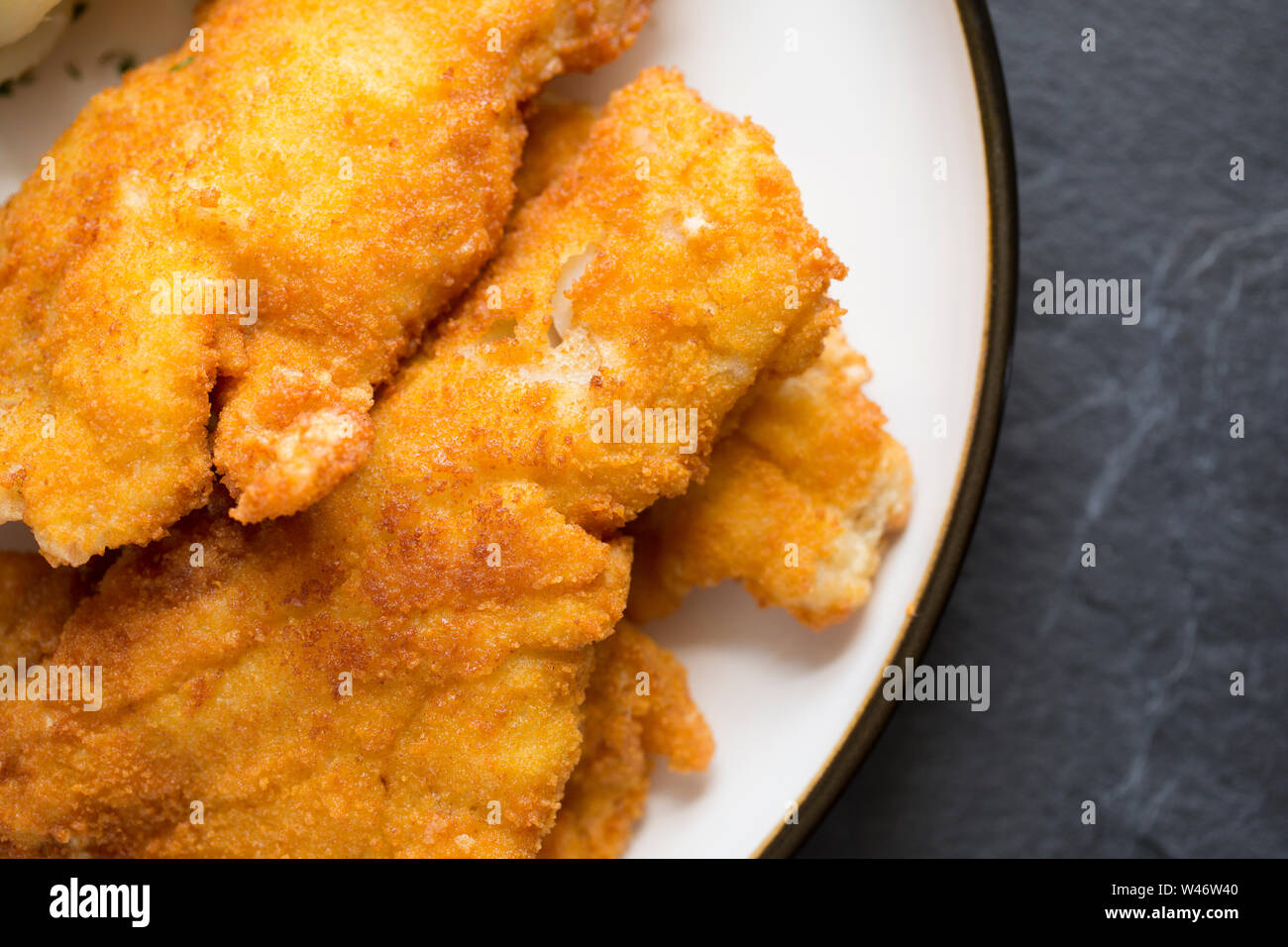 Fillets of Pouting, Trisopterus luscus, that have been dipped in flour