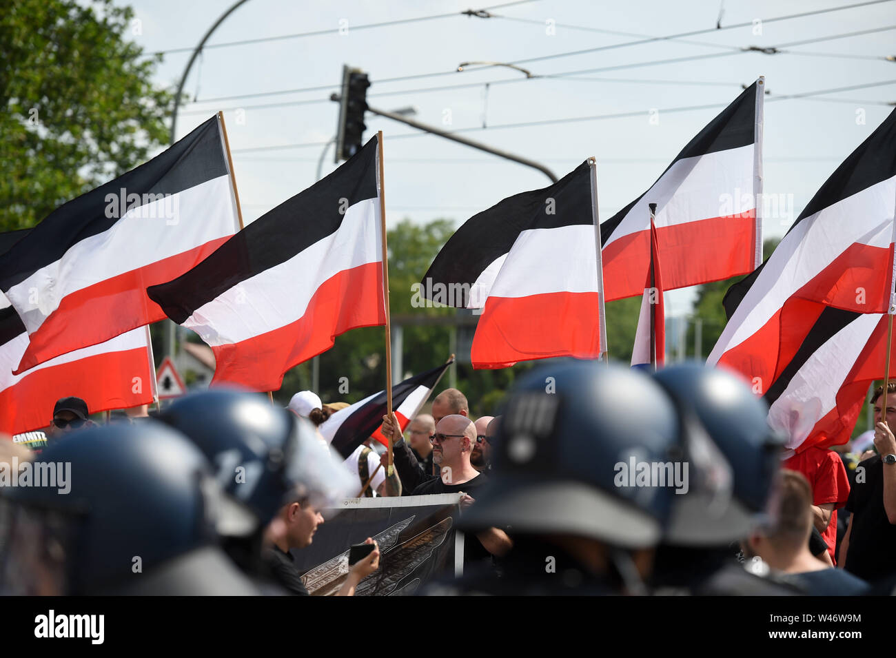 Hanover, Germany. Kassel, Germany. 20th July, 2019. Supporters of the small right-wing extremist party 'Die Rechte' (The Right) are flying their flags during the demonstration. The party had called for a demonstration in Kassel against media prejudgement in connection with the Lübcke case. A massive police presence is to prevent possible riots between the two camps. Credit: Uwe Zucchi/dpa/Alamy Live News Stock Photo